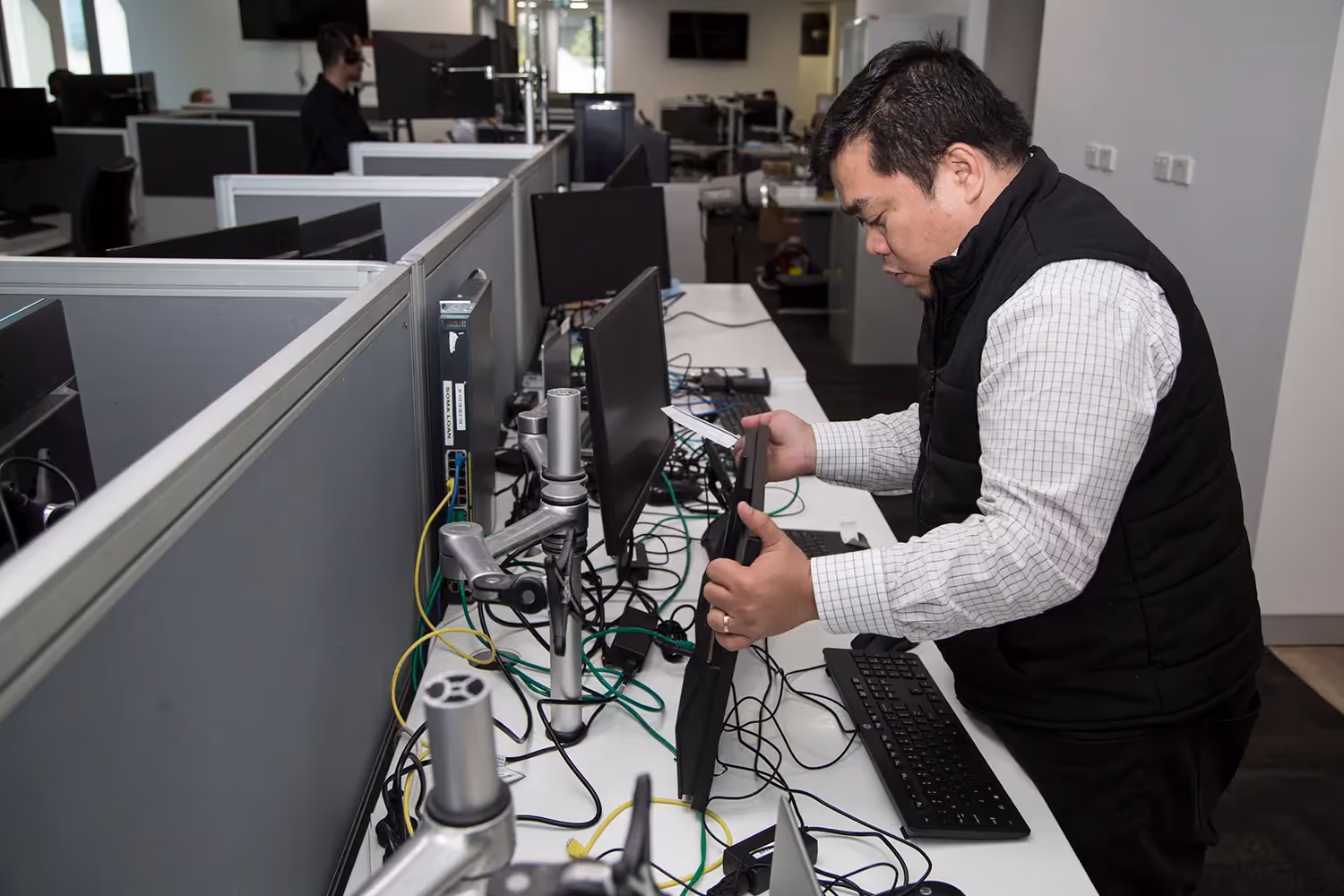 Technician installing cloud-based services for a local Sydney startup, with team members looking on