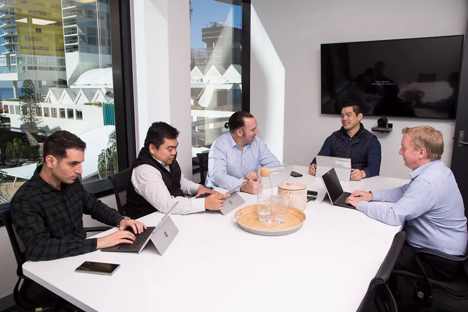 Friendly IT team members being welcomed on their first day in a modern managed services office in Sydney