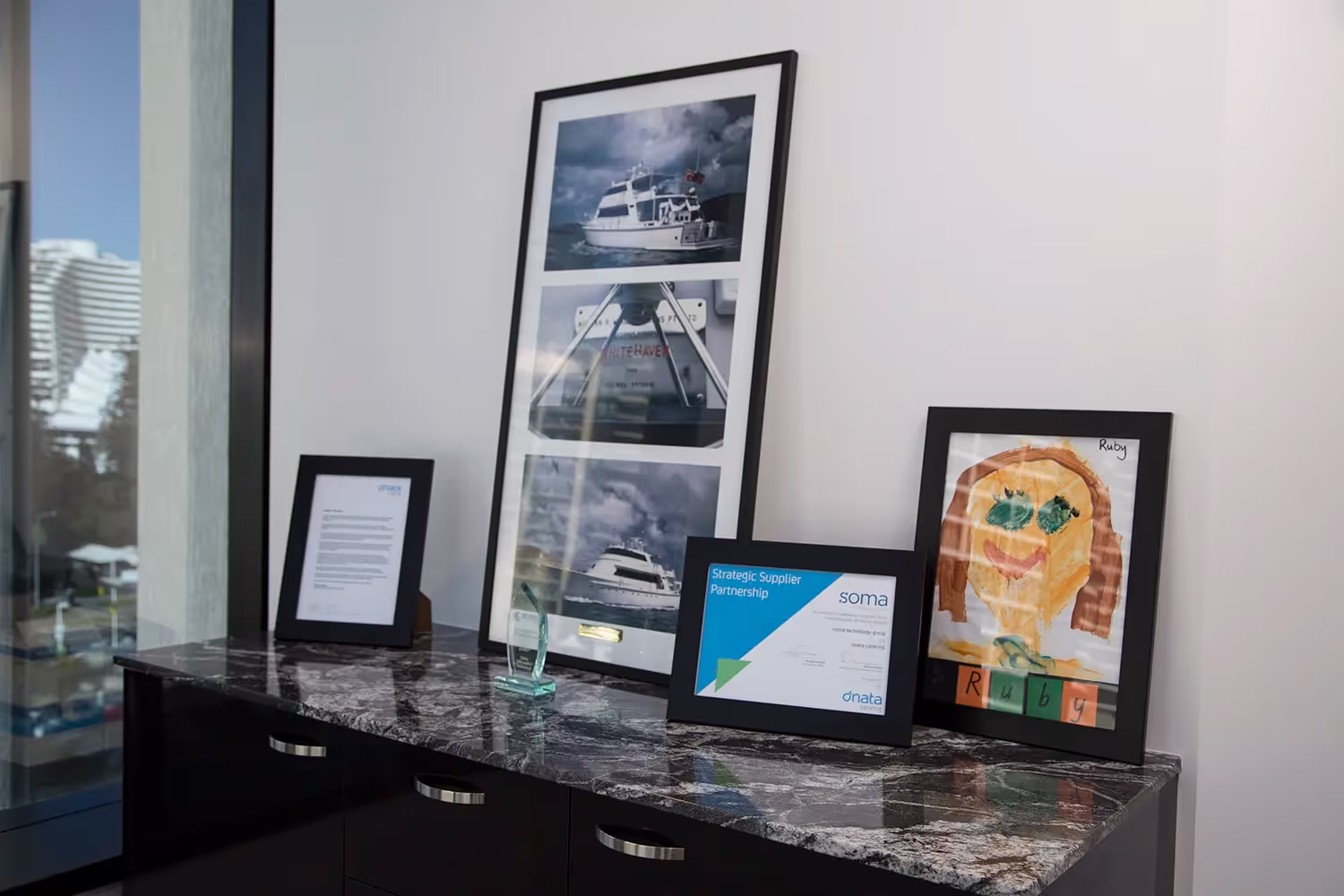 IT support team celebrating ISO and cybersecurity certifications in a Sydney workplace